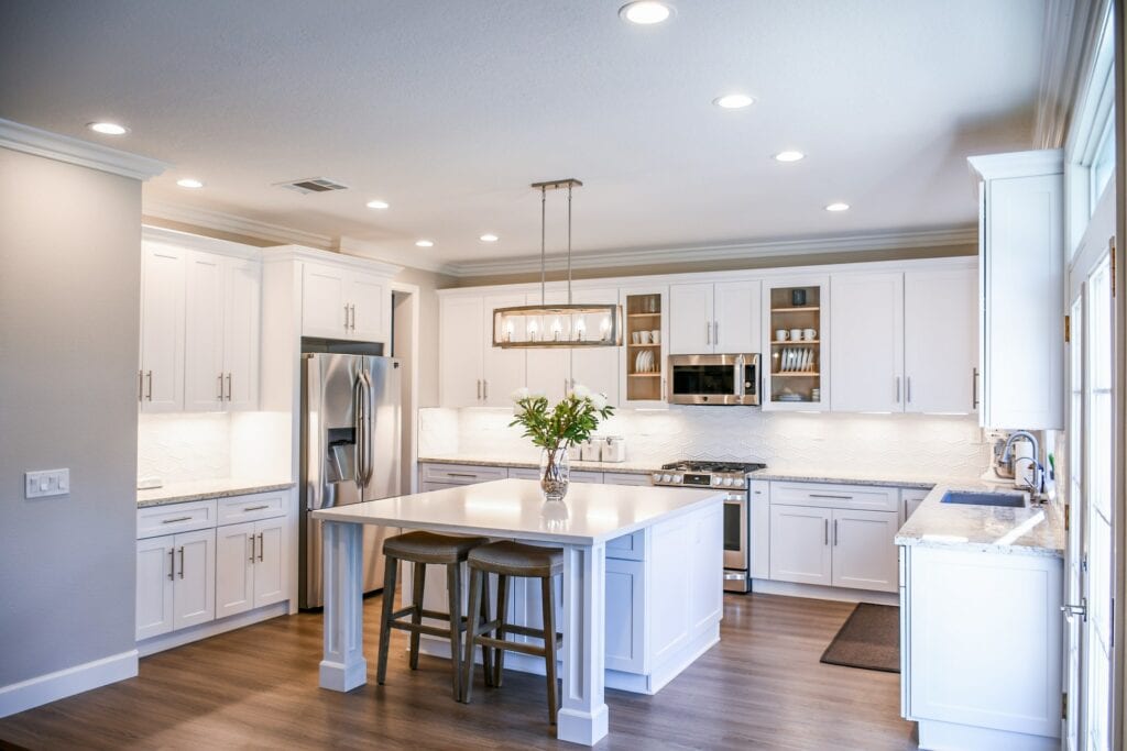 white kitchen with bright counter lights
